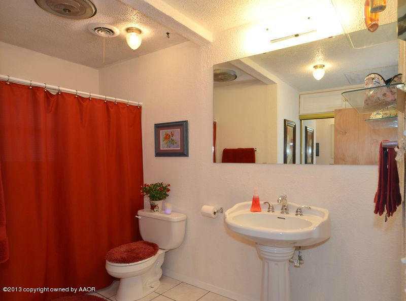 5111 Shield Drive Amarillo, TX 79110 - Photo 16 of 23 a bathroom with a sink toilet and mirror