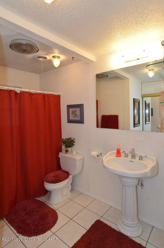 5111 Shield Drive Amarillo, TX 79110 - Photo 17 of 23 a bathroom with a sink toilet and mirror