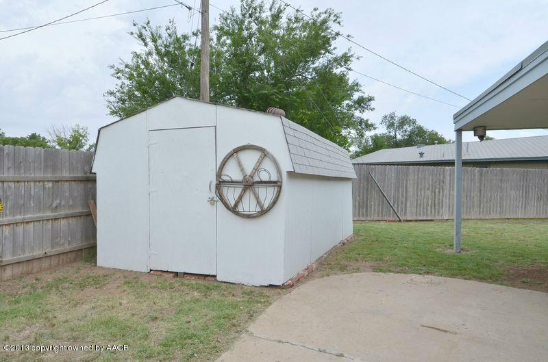 5111 Shield Drive Amarillo, TX 79110 - Photo 22 of 23 a view of a house with a small yard and a large tree