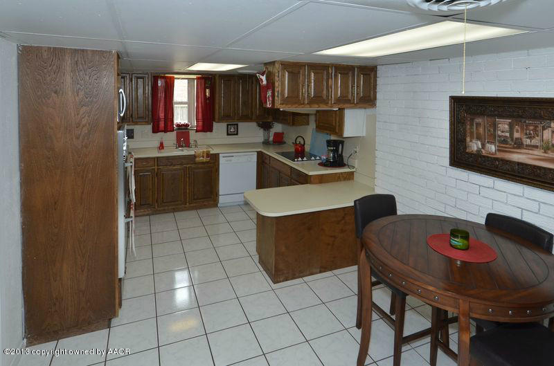 5111 Shield Drive Amarillo, TX 79110 - Photo 6 of 23 a kitchen with a sink a stove and chairs