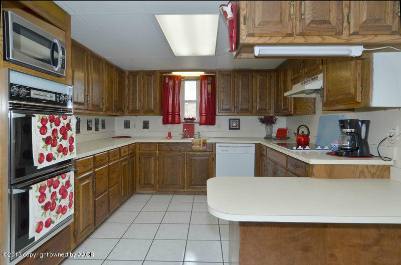 5111 Shield Drive Amarillo, TX 79110 - Photo 7 of 23 a kitchen with a cabinets a sink and a stove