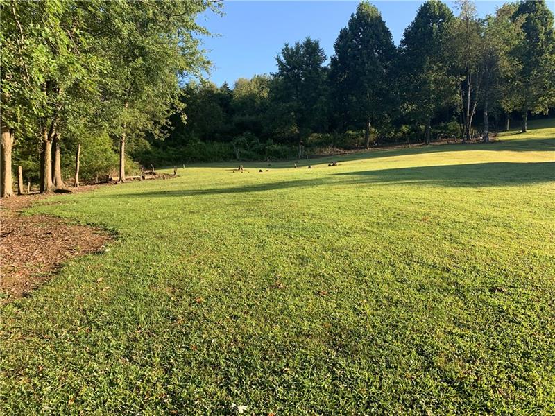 This is the view from the right btm corner of the property. Mostly wooded lot. Property goes much farther back than the trees at the back of pic.