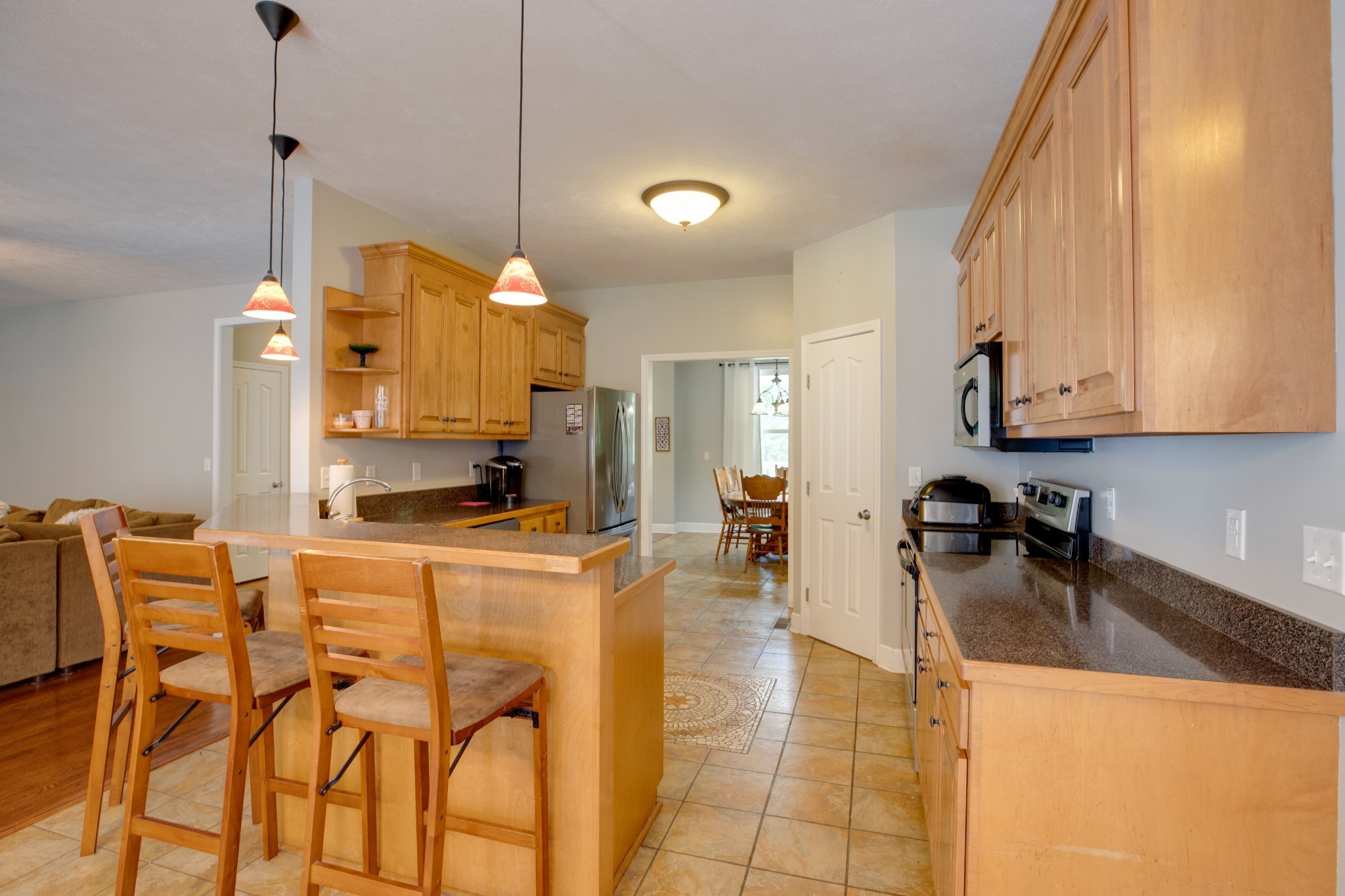 198 Arvitt Road Dickson, TN 37055 - Photo 11 of 36 a kitchen with stainless steel appliances kitchen island granite countertop a sink and cabinets