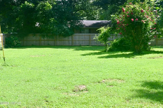 a view of a back yard from a room