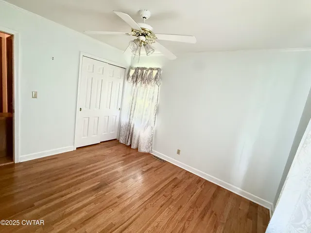 a bedroom with a bed and a mirror