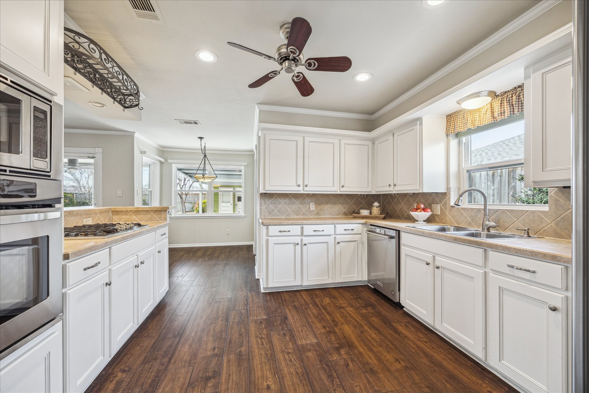 1251 Clovis Road Houston, TX 77008 - Photo 8 of 18 Built in oven, bar seating, KitchenAid dishwasher, recessed lighting, and a window over the sink