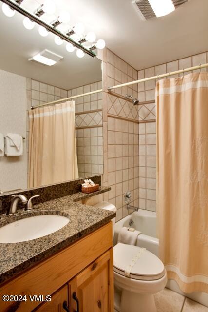 114 Willow Road, Unit 700 Vail, CO 81657 - Photo 5 of 6 a bathroom with a granite countertop sink toilet and shower