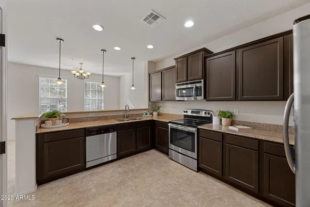 a view of kitchen with windows and ceiling fan