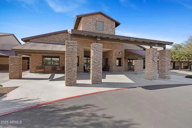a view of a swimming pool with a patio and a palm tree