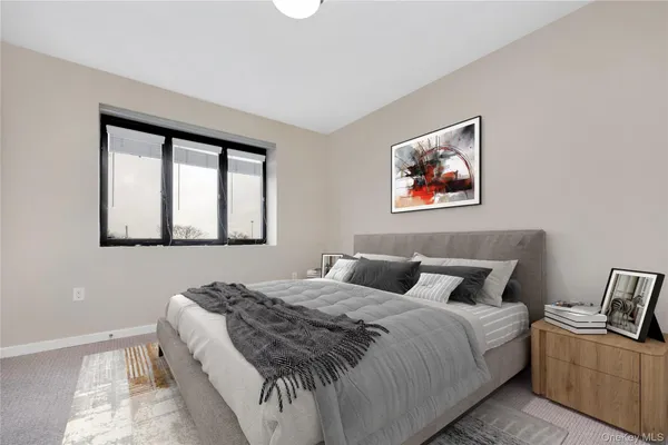a bedroom with a bed and a painting on the wall