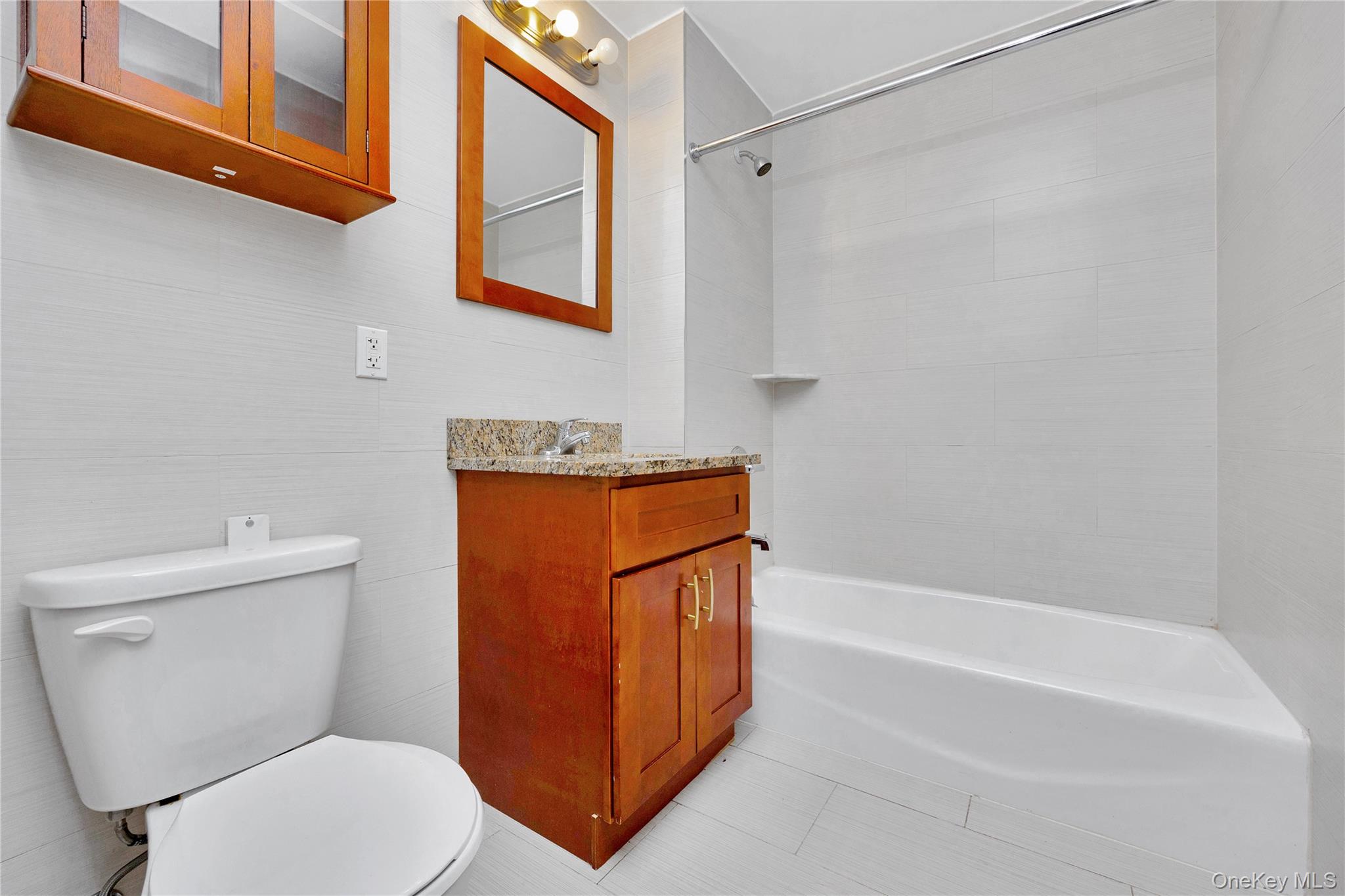 172-18 Jamaica Avenue, Unit 4D Queens, NY 11432 - Photo 8 of 23 a white toilet sitting next to a bath tub