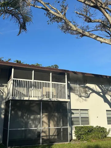 a view of a balcony with a floor to ceiling window and wooden fence