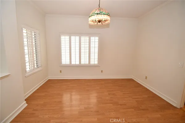a view of a dining room with furniture wooden floor and chandelier