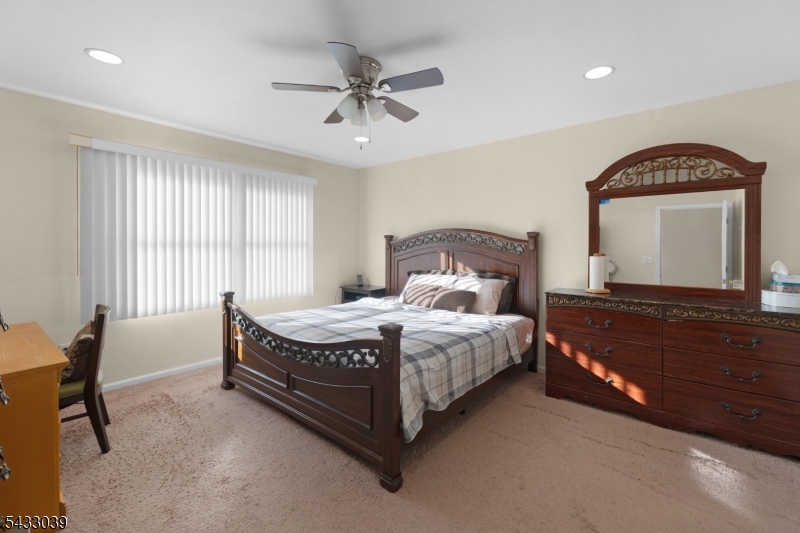 158 Autumn Ridge Road Morris Plains, NJ 07950 - Photo 23 of 26 a bedroom with a bed a chandelier and a dresser