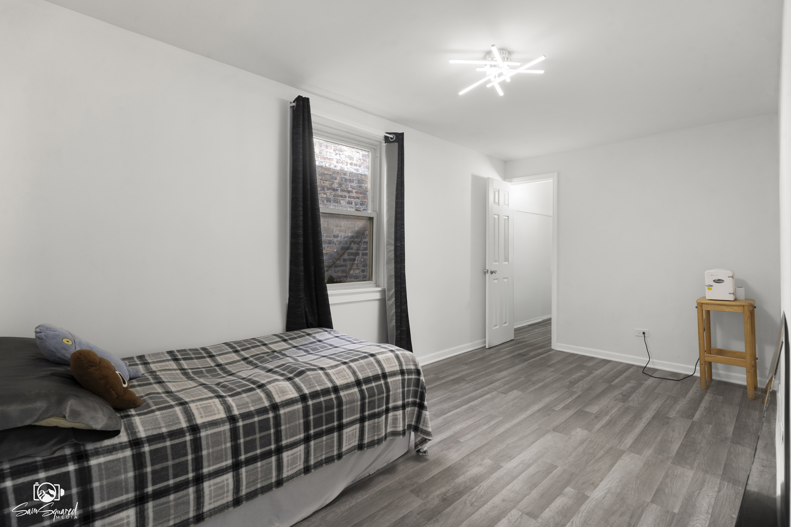 5636 South Carpenter Street Chicago, IL 60621 - Photo 12 of 27 a bedroom with a bed and a mirror