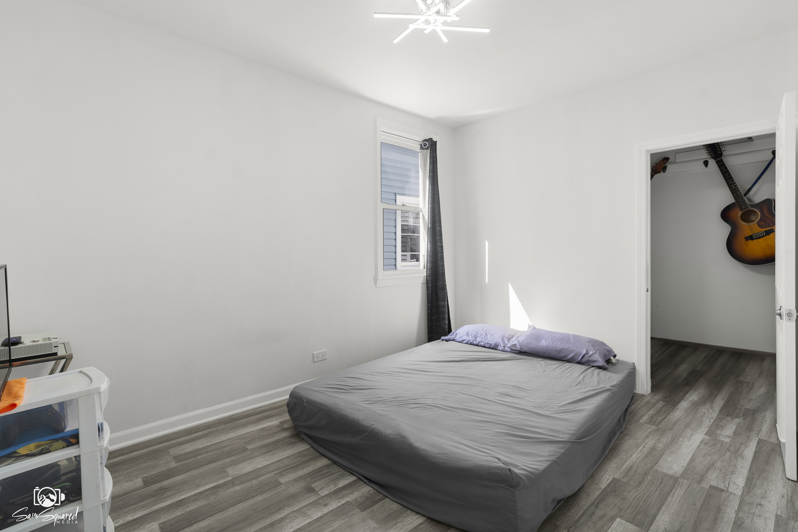 5636 South Carpenter Street Chicago, IL 60621 - Photo 13 of 27 a bedroom with a bed and a chandelier