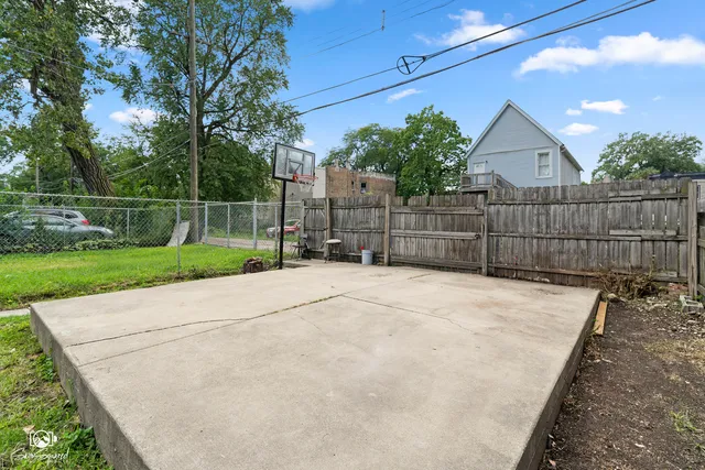 a view of backyard space with wooden fence