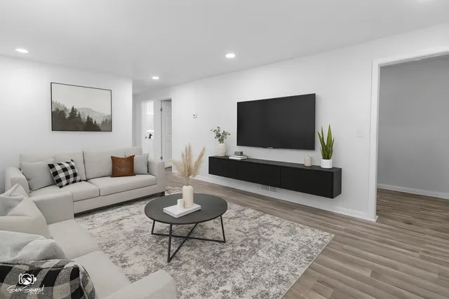a living room with furniture and a flat screen tv