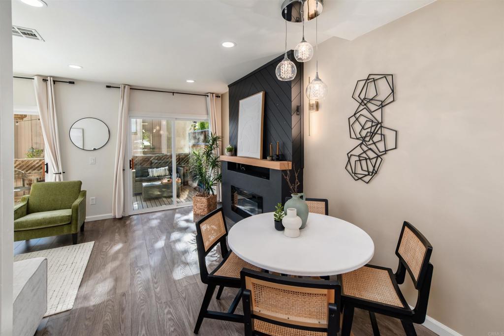 2349 Altisma Way, Unit B Carlsbad, CA 92009 - Photo 12 of 36 a view of a dining room with furniture and wooden floor