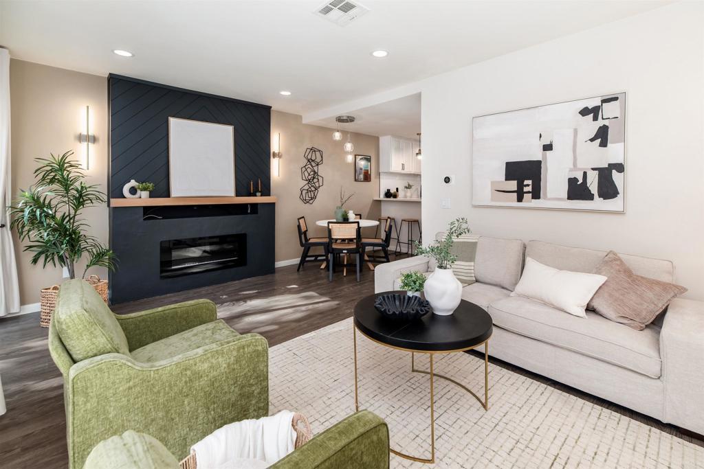 2349 Altisma Way, Unit B Carlsbad, CA 92009 - Photo 14 of 36 a living room with furniture a fireplace and a potted plant