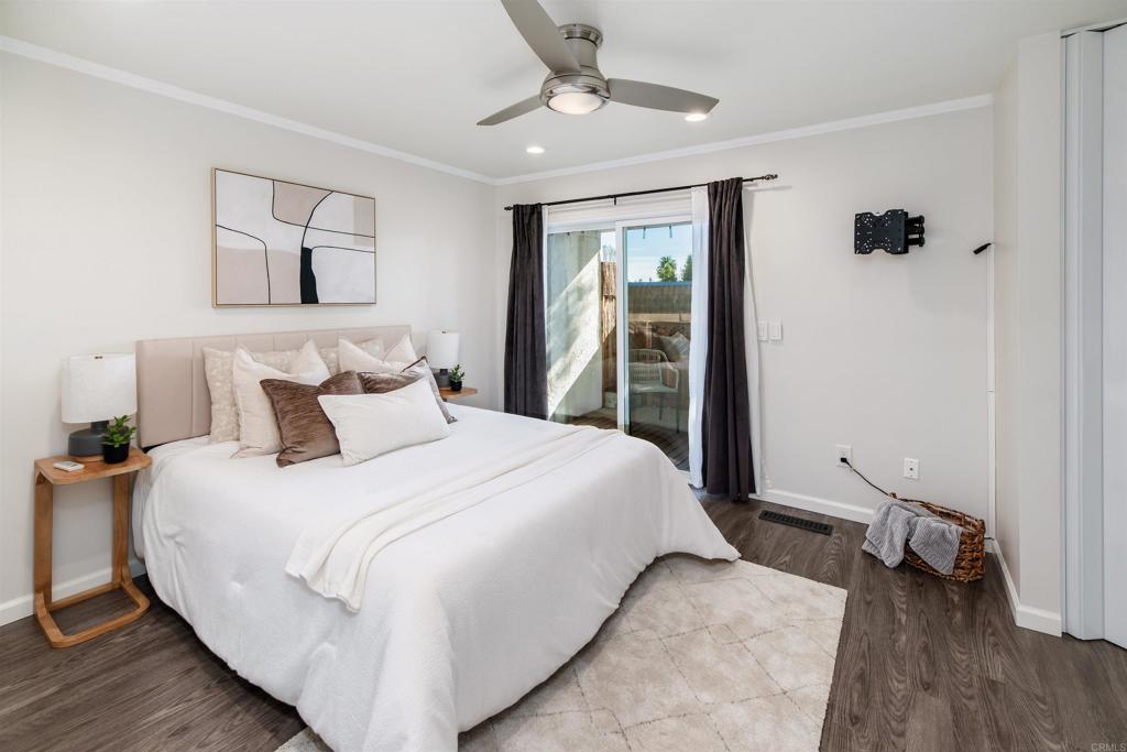 2349 Altisma Way, Unit B Carlsbad, CA 92009 - Photo 21 of 36 a spacious bedroom with a bed and a chandelier