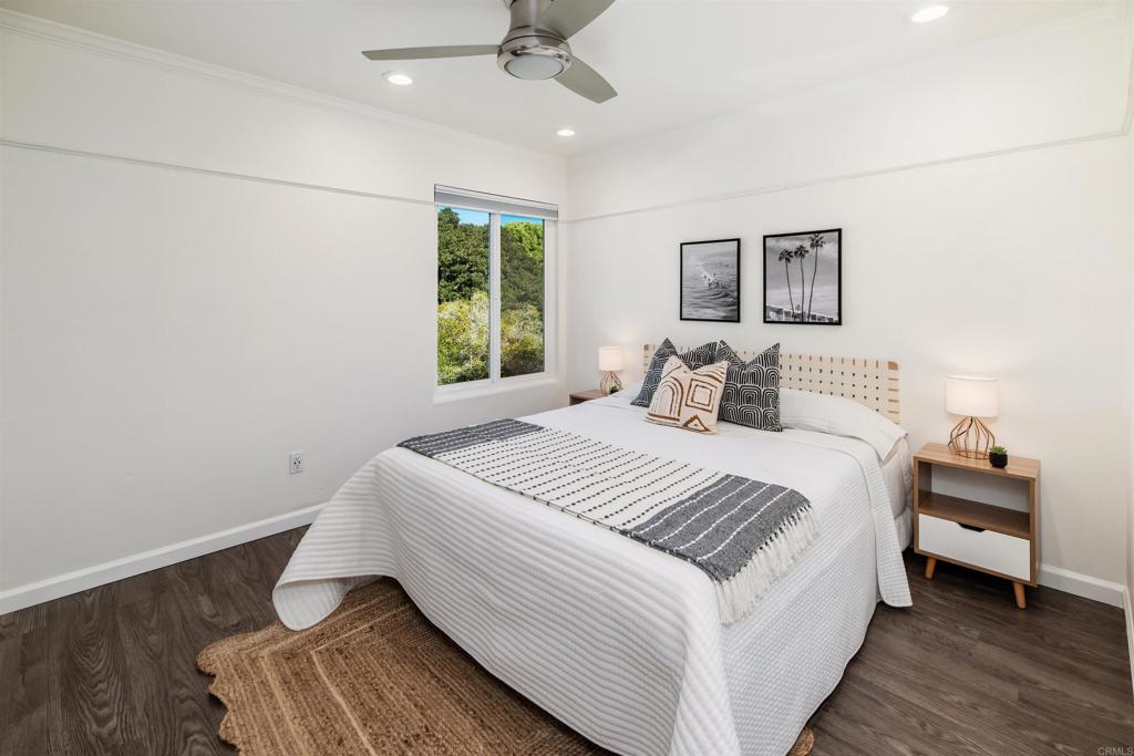 2349 Altisma Way, Unit B Carlsbad, CA 92009 - Photo 27 of 36 a bedroom with a large bed and a window
