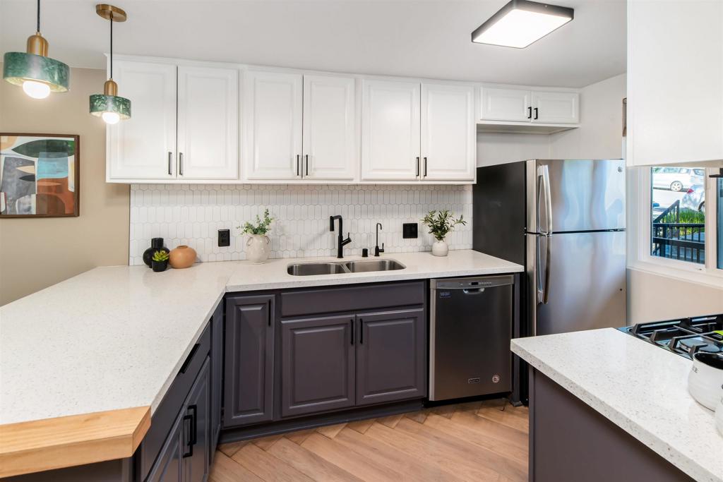 2349 Altisma Way, Unit B Carlsbad, CA 92009 - Photo 3 of 36 a kitchen with a sink a refrigerator and white cabinets