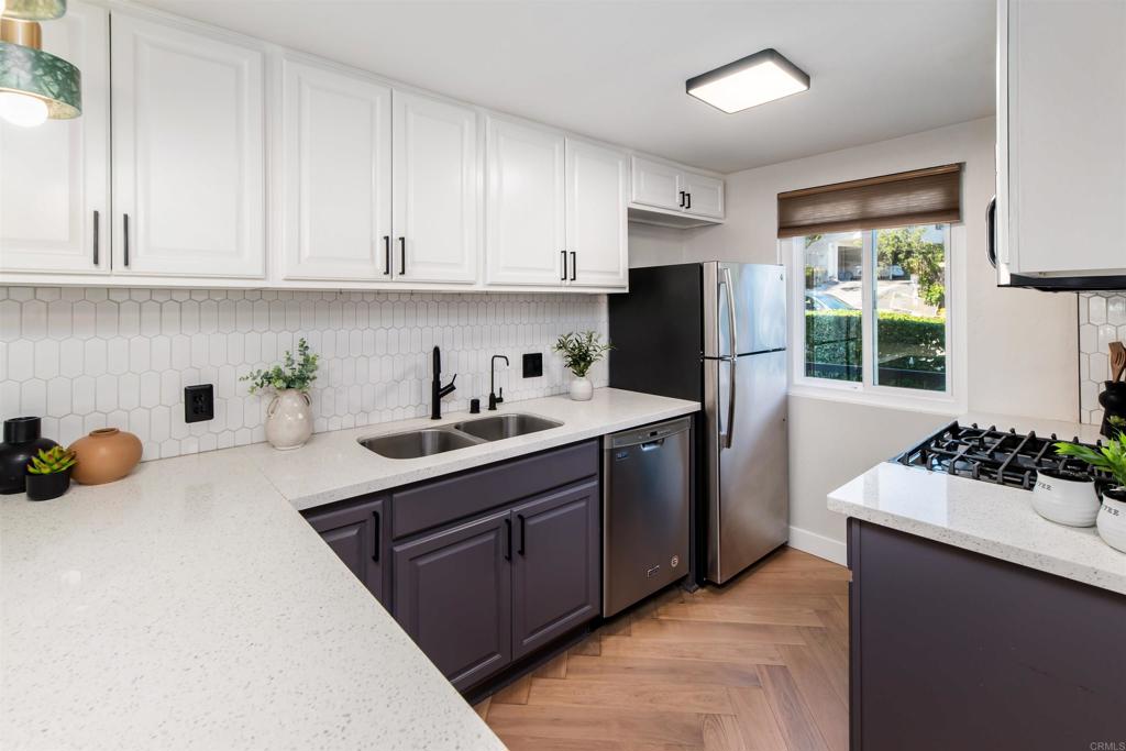 2349 Altisma Way, Unit B Carlsbad, CA 92009 - Photo 7 of 36 a kitchen with a sink and refrigerator