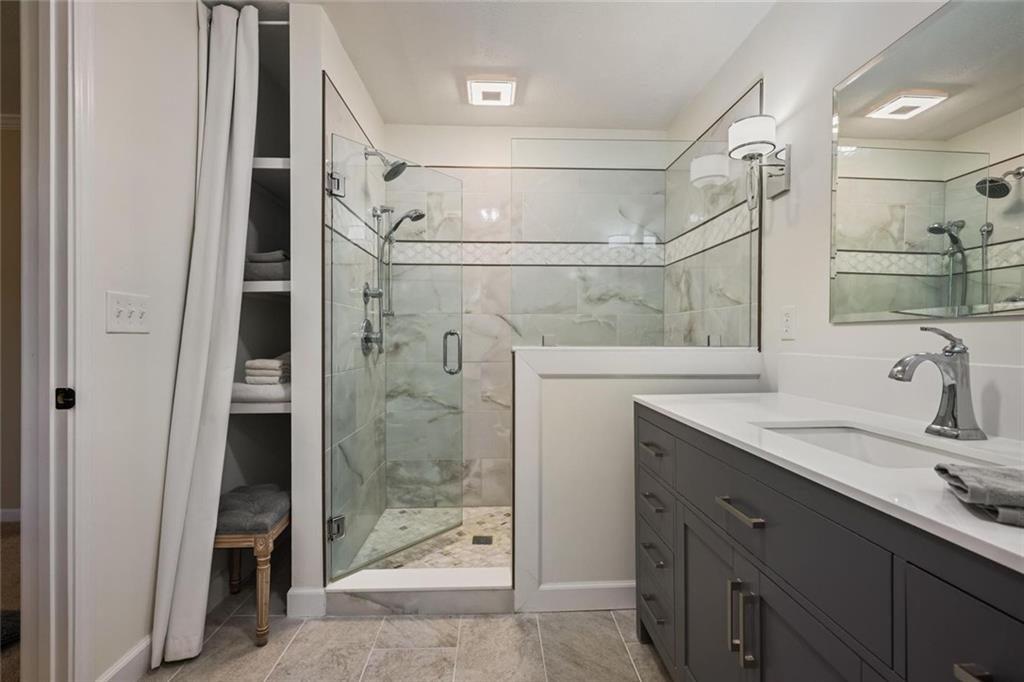 4505 Cochran Mill Road Fairburn, GA 30213 - Photo 23 of 36 a bathroom with a granite countertop shower sink and mirror