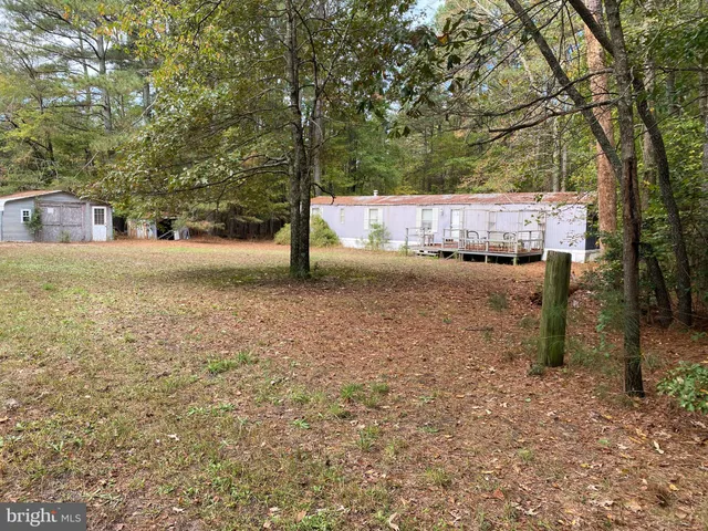 a backyard of a house with a parked and tree