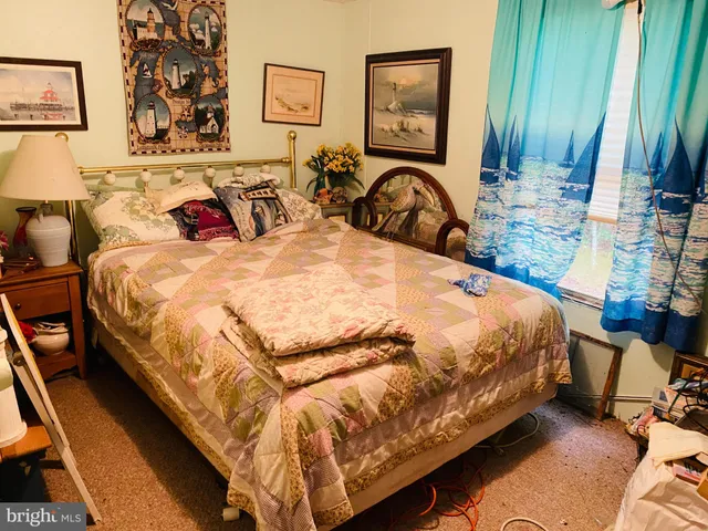 a bed sitting in a bedroom next to a window