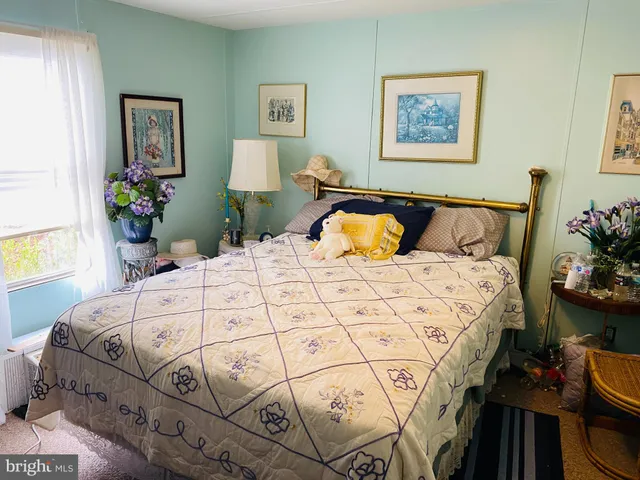 a bedroom with bed and painting on the wall