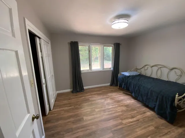 a bedroom with a bed and a window