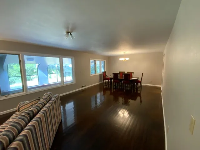 a view of a livingroom with furniture wooden floor and a window