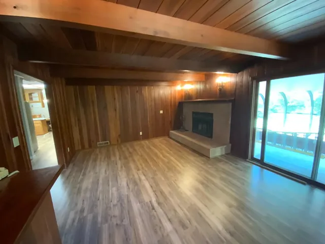 a view of hallway with wooden floor and fireplace
