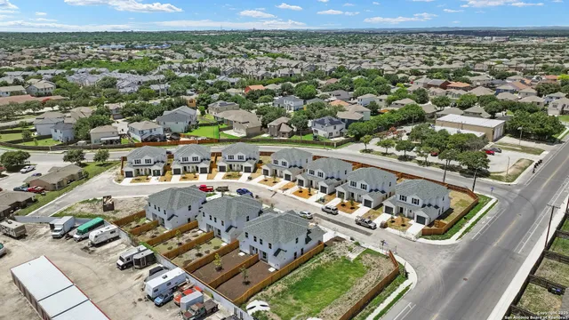 an aerial view of a residential houses with outdoor space