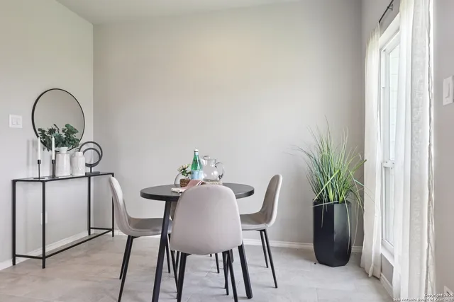 a view of a dining room with furniture and a potted plant