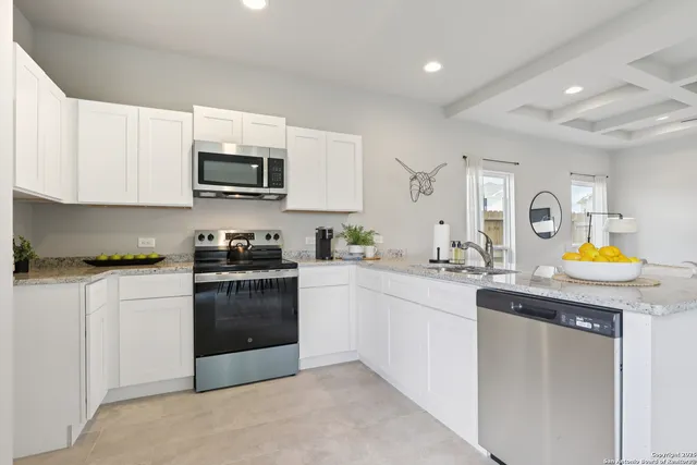 a kitchen with stainless steel appliances granite countertop a sink and a stove