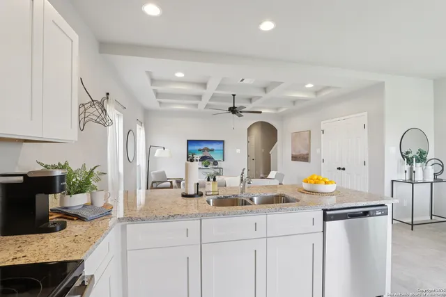 a kitchen with a sink a stove and cabinets