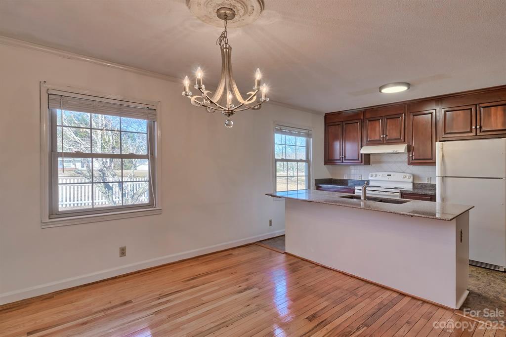 117 State Rd S-29-221 Kershaw, SC 29067 - Photo 11 of 28 a kitchen with stainless steel appliances granite countertop a sink dishwasher a refrigerator cabinets and wooden floor
