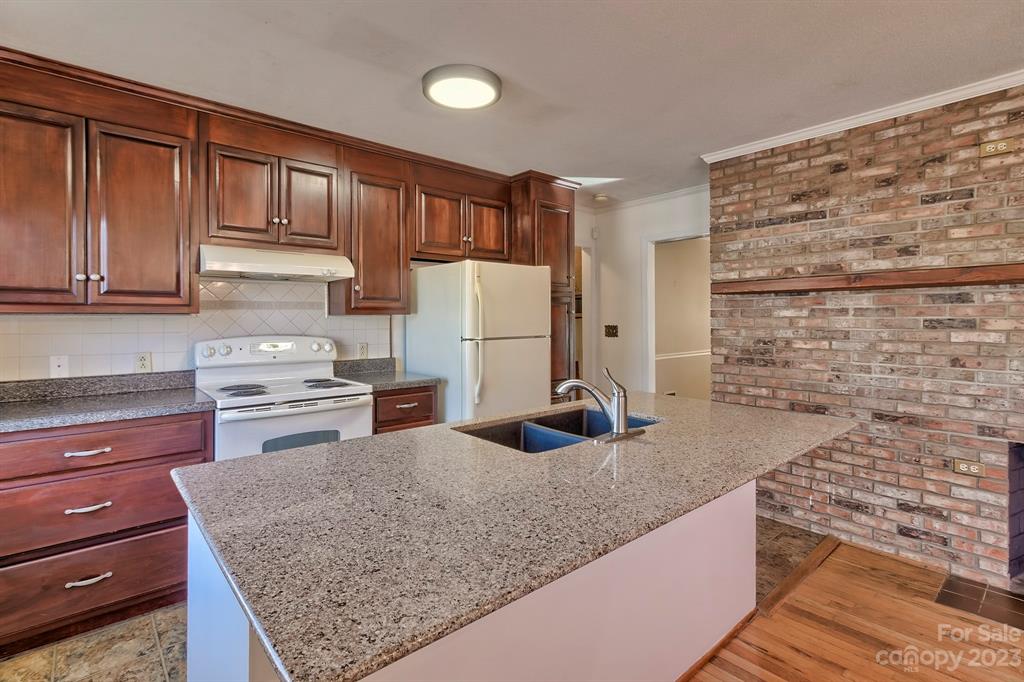 117 State Rd S-29-221 Kershaw, SC 29067 - Photo 14 of 28 a kitchen with stainless steel appliances granite countertop a sink stove and refrigerator