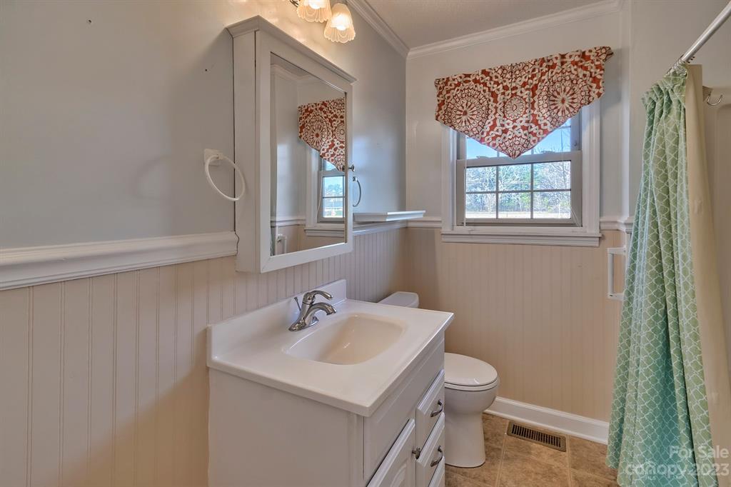 117 State Rd S-29-221 Kershaw, SC 29067 - Photo 22 of 28 a bathroom with a sink a toilet and a mirror