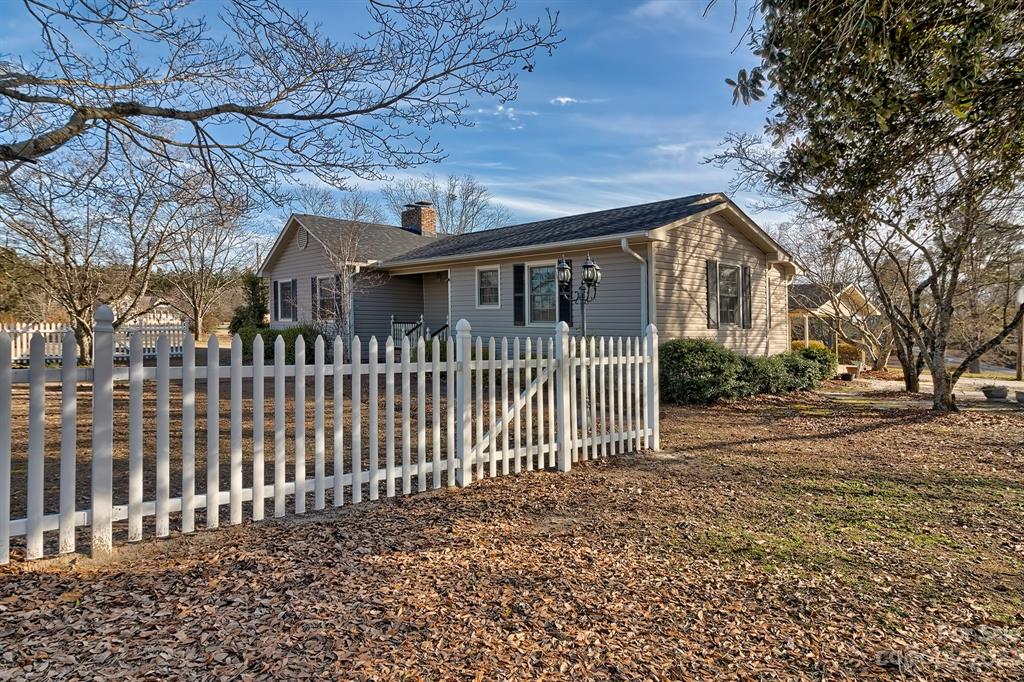 117 State Rd S-29-221 Kershaw, SC 29067 - Photo 4 of 28 a front view of a house with a garden