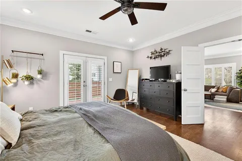 a bedroom with furniture and a flat screen tv