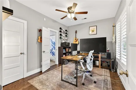 a work room with furniture and a flat screen tv