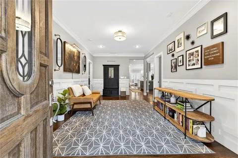 a living room with furniture a rug and a window