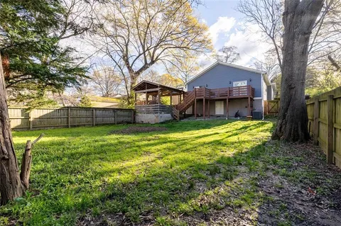 a house view with a sitting space and garden