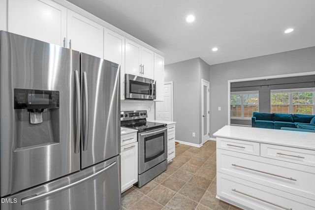 a kitchen with stainless steel appliances a refrigerator stove and microwave