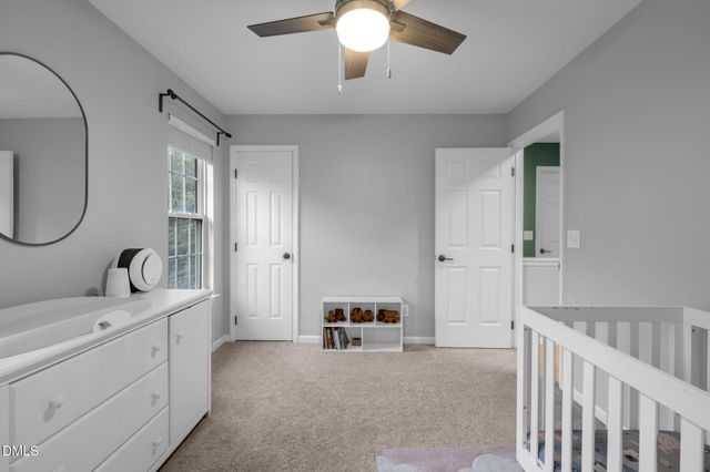 a living room with furniture and a mirror