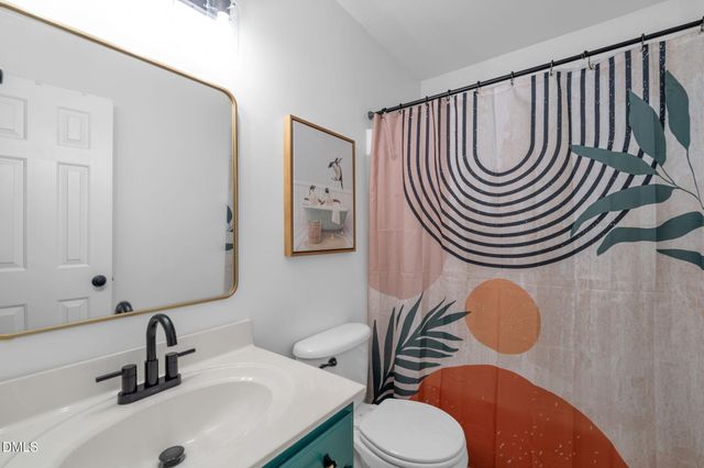 a bathroom with a sink a mirror a toilet and a mirror